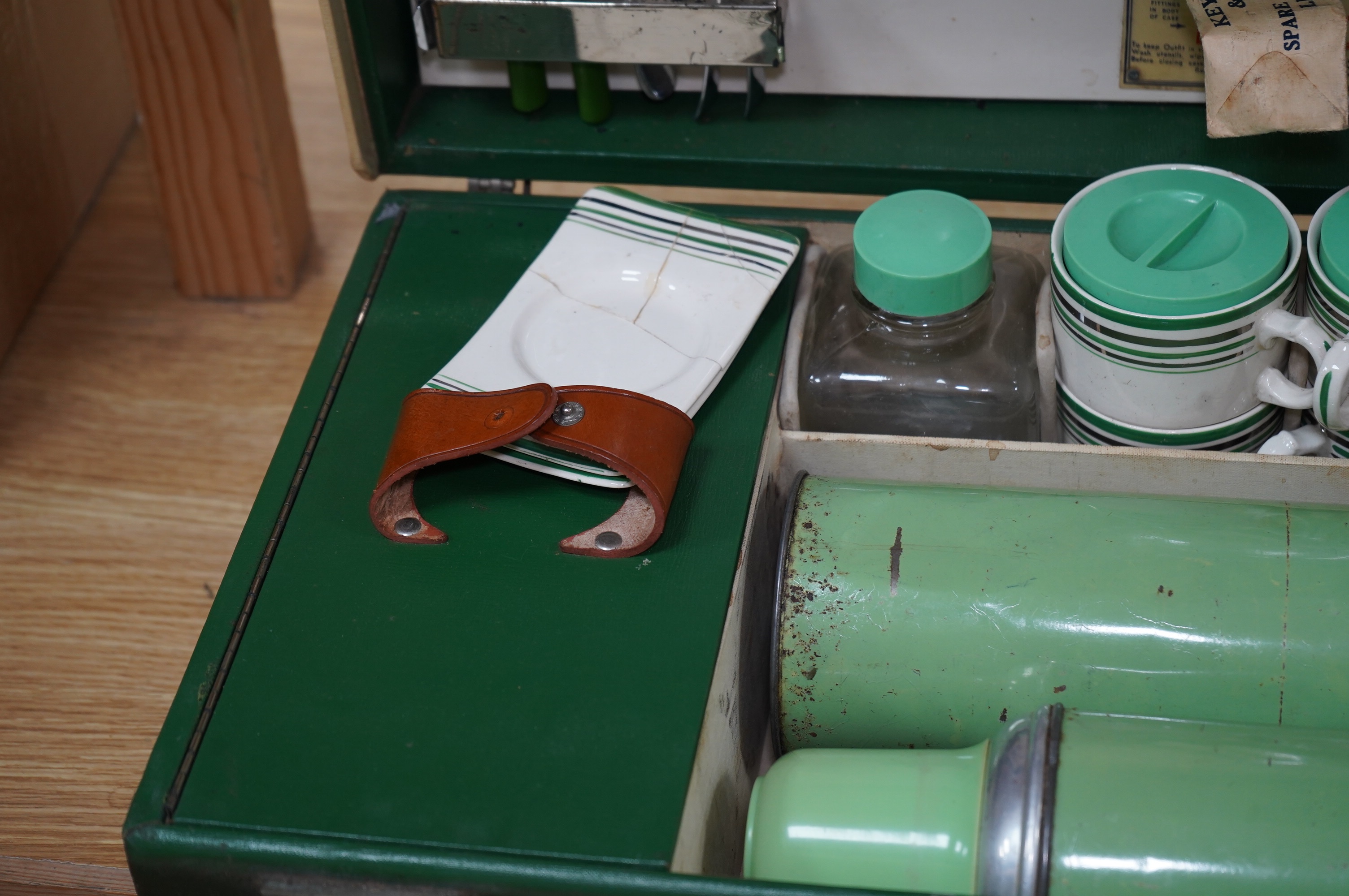 An Art Deco, c.1930's cased picnic set with flasks, cutlery, plates and cups. Condition - poor